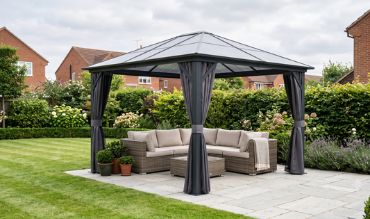 Modern UK suburban garden with grey-stone patio, Outsunny 3.6 x 4m hardtop gazebo, beige rattan corner sofa, potted lavender,