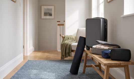 A neatly packed, modern UK family holiday setup: lightweight Kono suitcase, foldable travel bag, reusable packing cubes, and 