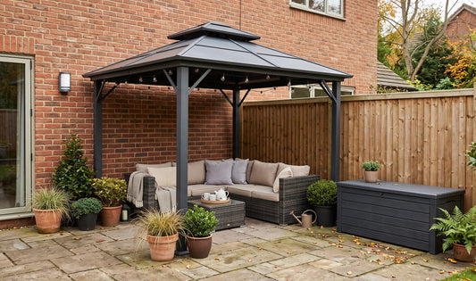 Practical garden outdoor essentials on a small UK patio with a gazebo, storage box and outdoor lighting on a tidy terrace