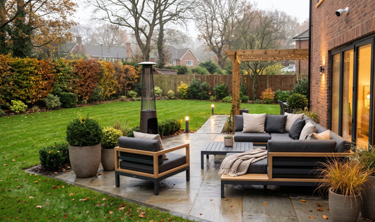 Modern UK suburban garden patio with weather-resistant seating and shelter essentials under warm outdoor lighting.